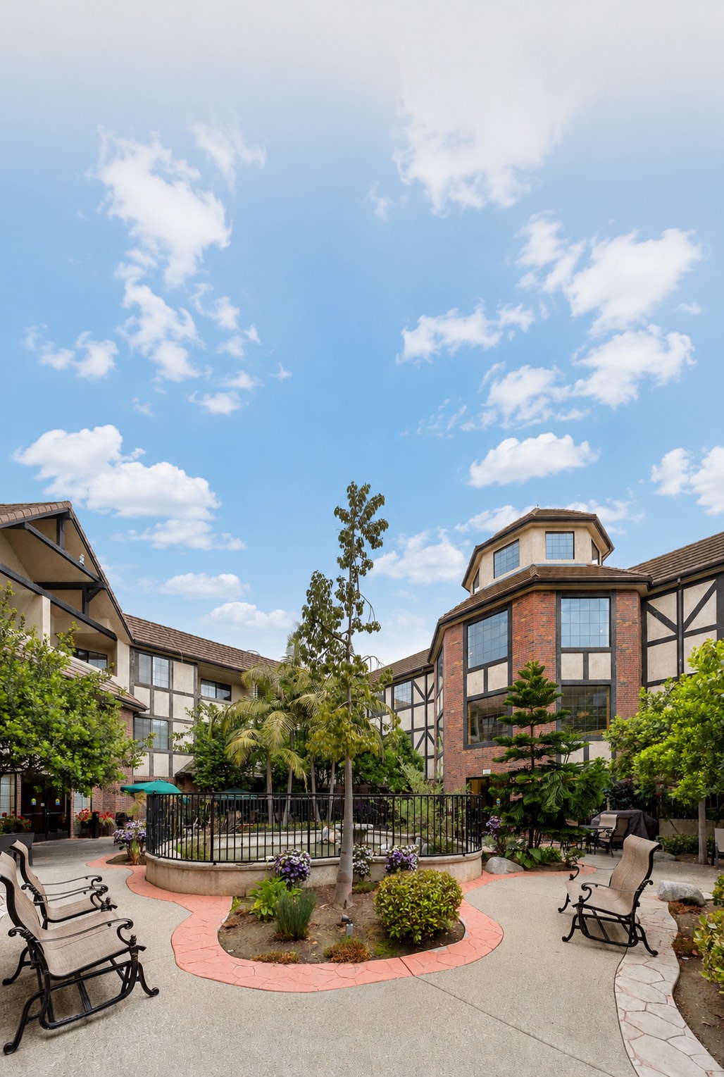 The courtyard, with benches, a fountain and the building around it